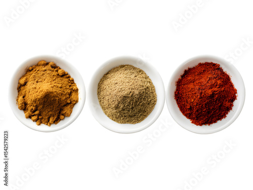 Fototapeta Naklejka Na Ścianę i Meble -  A top view of three small white bowls filled with different colored spices on a black background