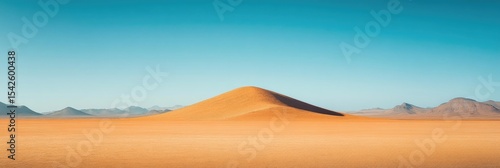 Vast desert landscape with a single dune under a vibrant blue sky