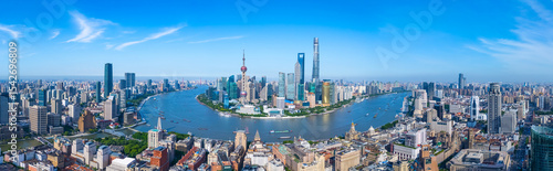 Panoramic Aerial view of Shanghai skyline and winding river on sunny day.