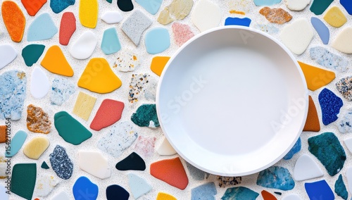 White plate on colorful mosaic tile