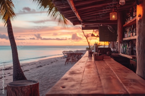 Fototapeta Naklejka Na Ścianę i Meble -  Wooden beach bar at sunset over the ocean.