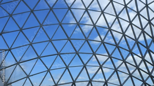 Large, clear dome with a blue sky above it. The dome is made of many small, triangular pieces of glass
