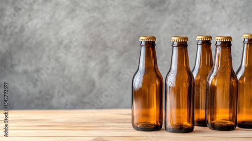 Empty brown glass bottles arranged on a wooden table. 