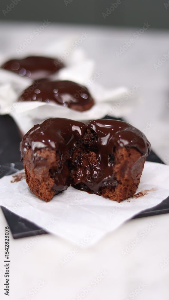 chocolate cake wrapped in cake paper with chocolate glaze topping chocolate cake wrapped in cake paper with chocolate glaze topping