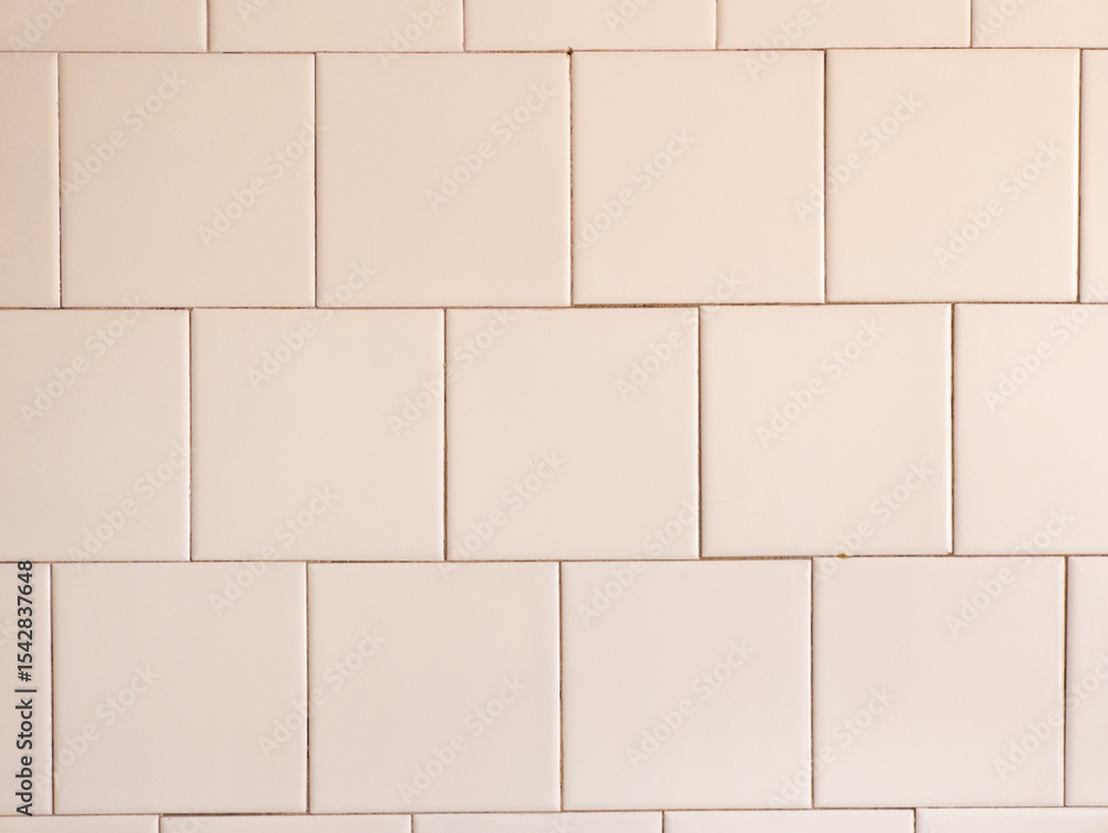 Naklejka premium A white tiled wall with a white brick pattern