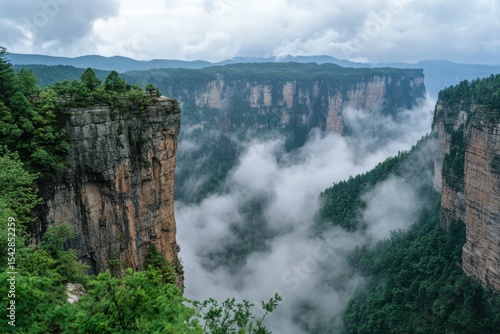 Cloudy mountain landscape showcasing dramatic cliffs and misty valleys at an elevated viewpoint, Cloudy natural landscape on the top of mountain in China