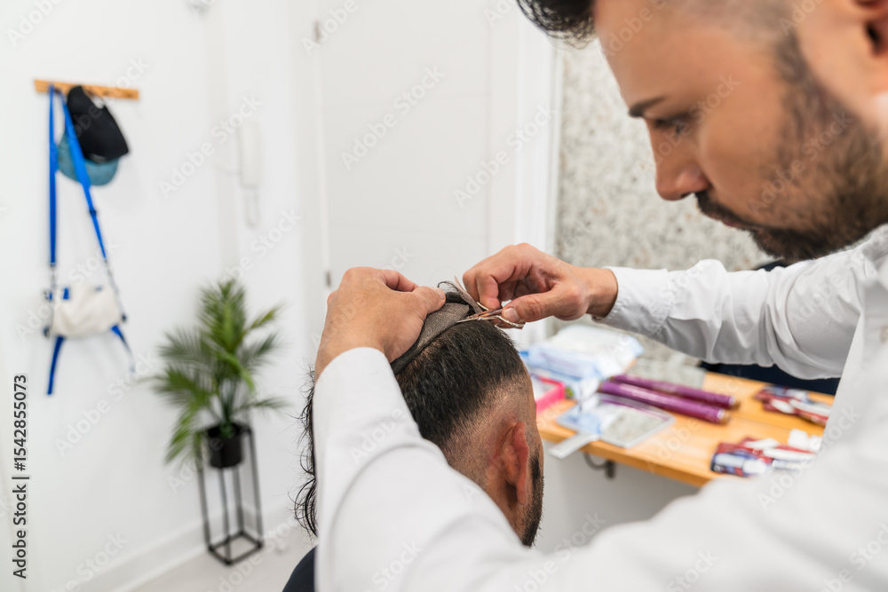 © Koldo_Studio - Hair clinic specialist attaching hair replacement system to client, offering solution for hair loss and boosting self confidence