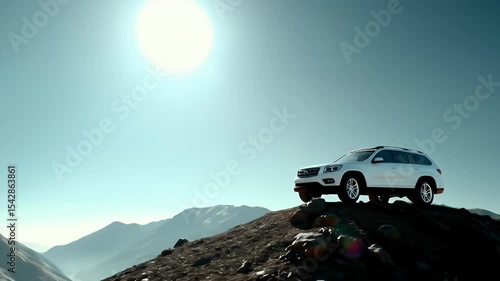 White SUV on a rocky mountain peak under a bright sun