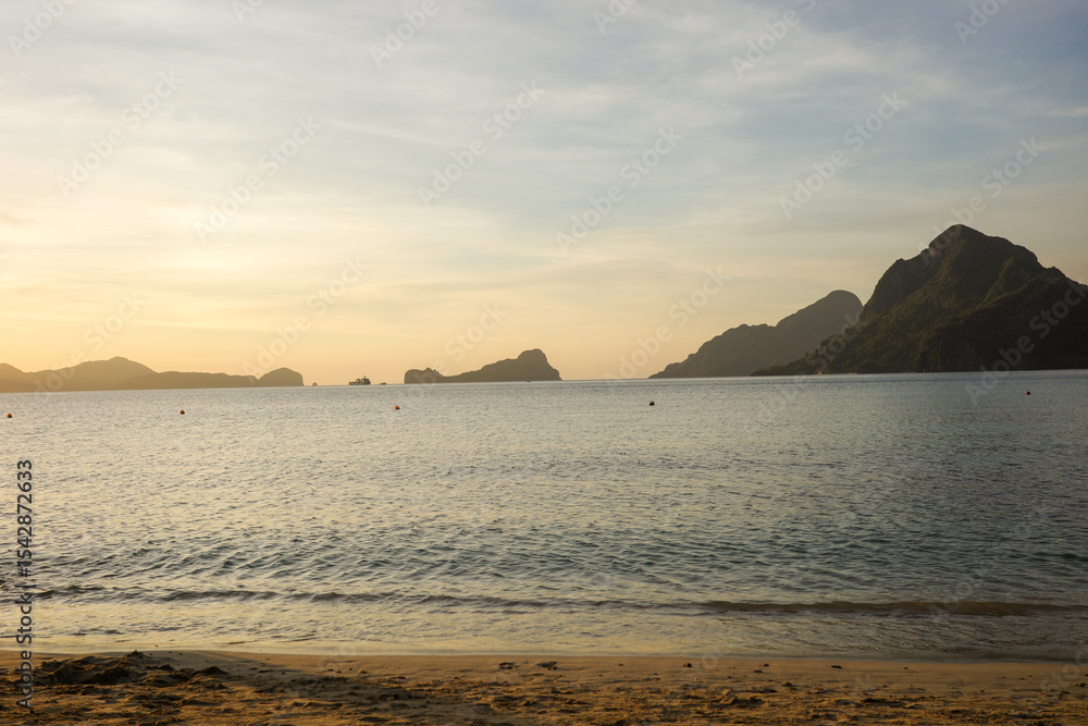 Landscape of a beautiful sunset in Vanilla beach, Coron, Palawan. The last sun ray of the day is the magical moment when the ocean feels warmer. Top tourist attraction in Philippines, Asia Landscape of a beautiful sunset in Vanilla beach, Coron, Palawan. The last sun ray of the day is the magical moment when the ocean feels warmer. Top tourist attraction in Philippines, Asia