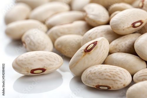 A collection of white beans on a white background, highlighting their natural shape.