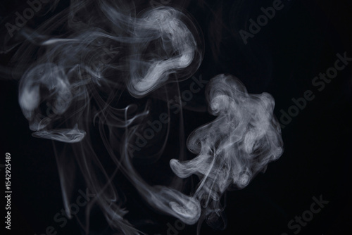 White Smoke Swirls on Black Background for Composite Use

