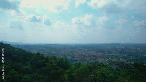 The Aerial Footage of Hilly Rain Forest in Indonesia Captured with the Villages at the Background, Captured with A Drone