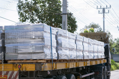 Truck Transporting Wrapped Construction Materials on Rural Road