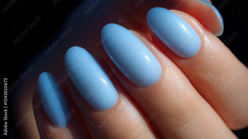 Close-up of a person's hand with their fingernails painted in a light blue color. the nails are long and pointed, with a glossy finish. Close-up of a person's hand with their fingernails painted in a light blue color. the nails are long and pointed, with a glossy finish.