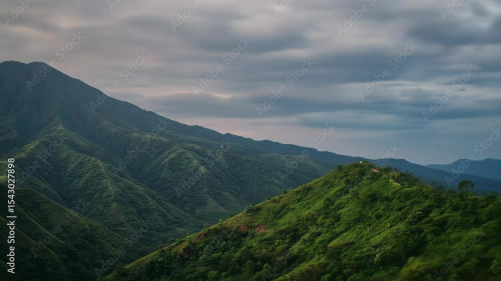 Volcanic mountain peak over lush landscape Volcanic mountain peak over lush landscape