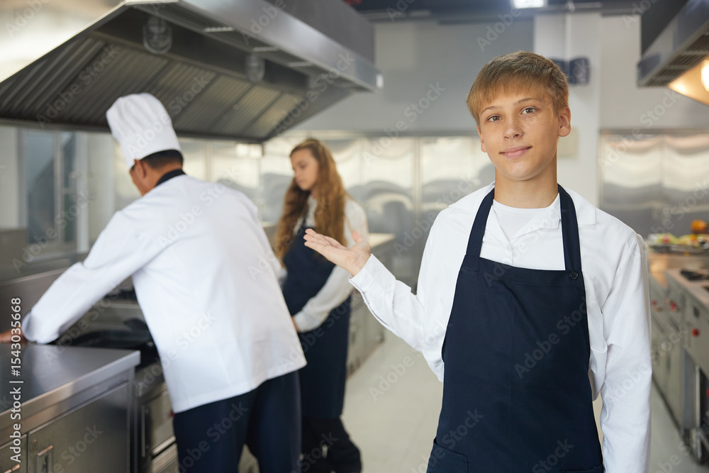 Fototapeta premium portrait young chef showing pose in the kitchen