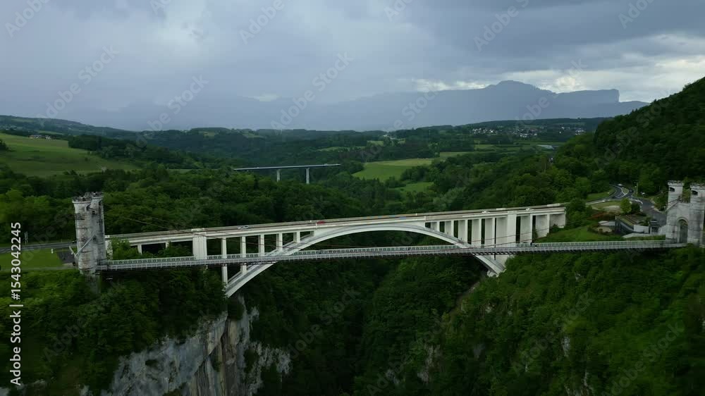Aerial: Caille Bridge and Caquot Bridge during the day with cloudy sky in Allonzier-la-Caille Cruseilles, Haute-Savoie, France, pull out drone shot Aerial: Caille Bridge and Caquot Bridge during the day with cloudy sky in Allonzier-la-Caille Cruseilles, Haute-Savoie, France, pull out drone shot