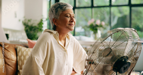 Tableau sur toile Elderly woman, hot and fan at house for heatwave, air conditioning and menopause symptoms