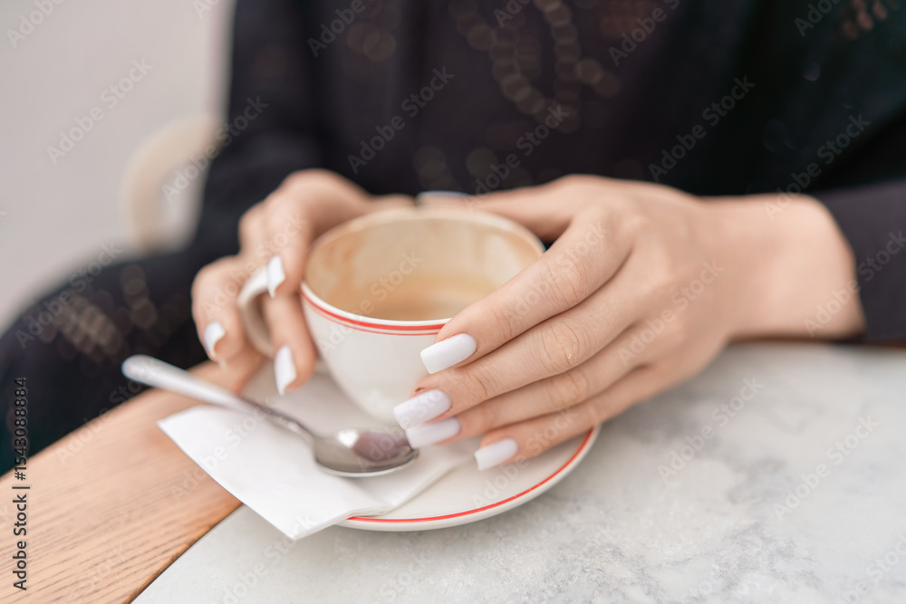 Coffee Hands Nails: Woman holds empty cup in cafe, showing white manicure after drinking. Coffee Hands Nails: Woman holds empty cup in cafe, showing white manicure after drinking.