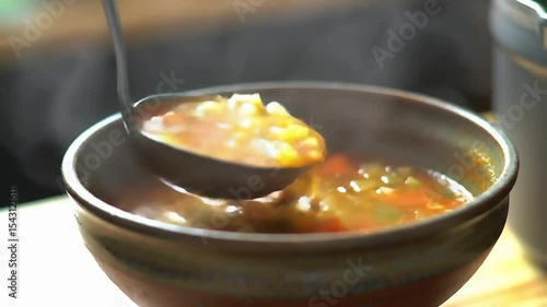 A pot of soup ladled into a bowl