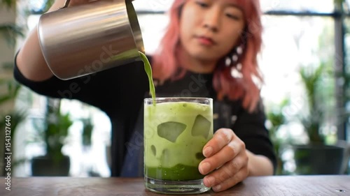 Woman Pouring Iced Matcha Drink