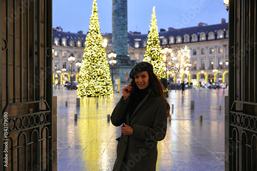 Photography Woman enjoying Christmas lights in festive Paris streets