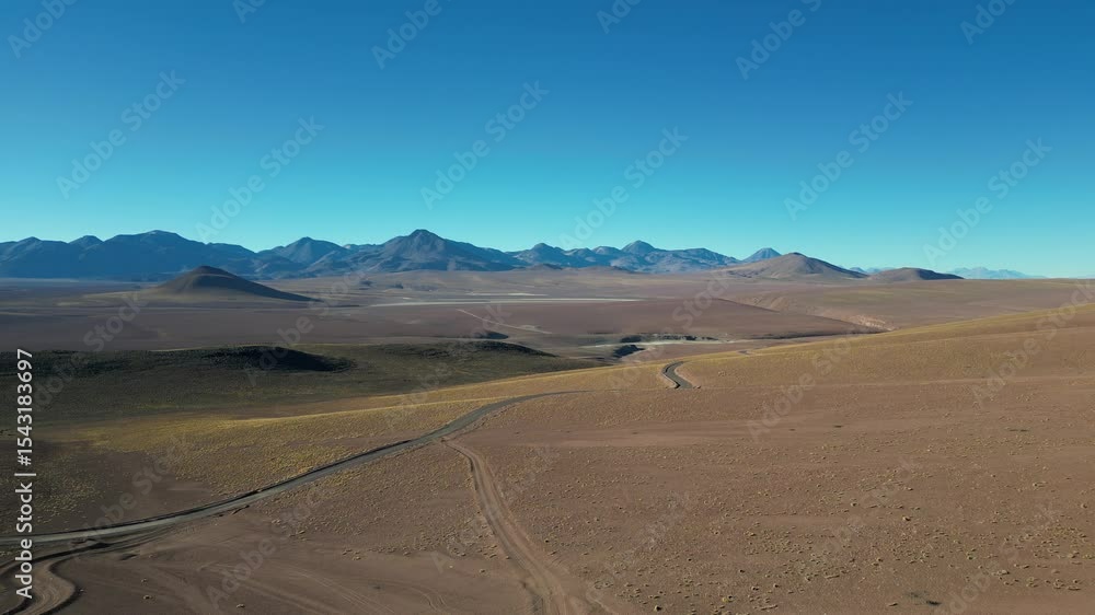 Paths trace the contours of Chile otherworldly Atacama Desert, framed by distant peaks Paths trace the contours of Chile otherworldly Atacama Desert, framed by distant peaks