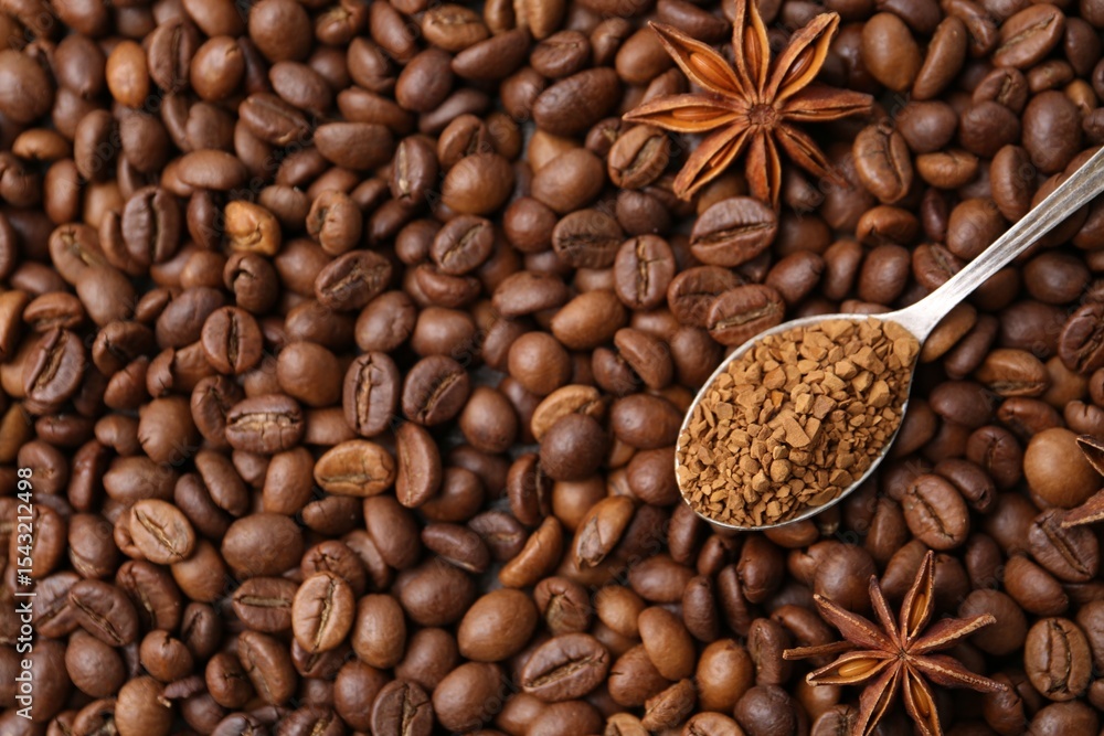 Fototapeta premium Spoon with granulated instant coffee and star anise on beans, top view. Space for text