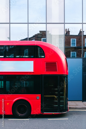 Canvas Print Classic red double-decker bus parked on london street with blank billboard