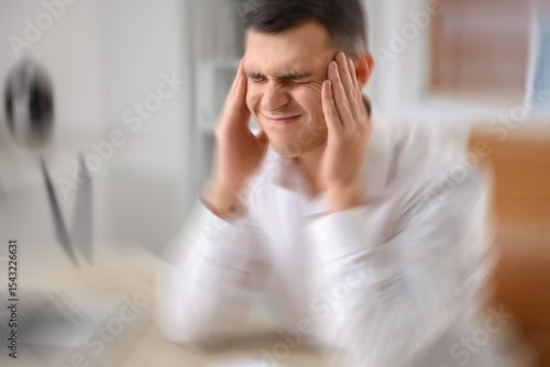 Young businessman suffering...