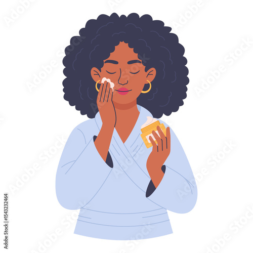 Woman in bathrobe applying face cream isolated on white background, skin care concept