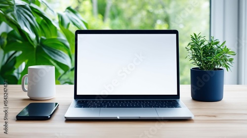 A modern workspace featuring a laptop with a blank screen, a coffee mug, a smartphone, and a potted plant on a wooden desk.