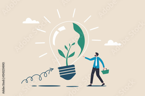 Ecology and sustainable business, green idea or protection against world climate change, environmental care concept, smart businessman watering seedling sprout growing inside green lightbulb idea.
