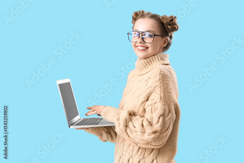 Smiling young woman in glas...