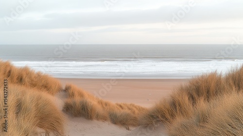 Fototapeta Naklejka Na Ścianę i Meble -  Serene coastal dune landscape; calm ocean waves, pale sand, and tall grasses