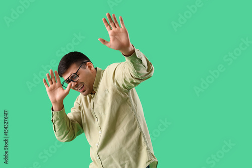 Afraid young man in eyeglas...