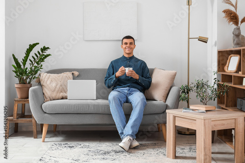 Handsome young man with cup...