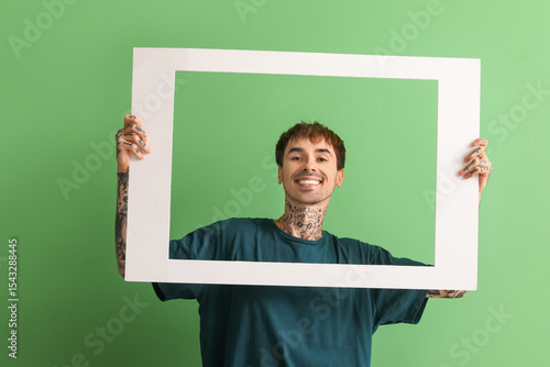 Happy young man holding whi...