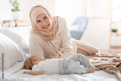 Motherhood and maternity care, smiling young muslim woman wearing hijab resti...