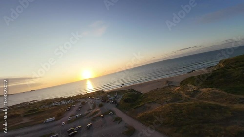 Nature, Coastal landscape, Ocean, Sea, Sand, Shore, Waves, Dunes, Cliff, Trees, Sunshine, Golden hour, Horizon, Tranquility, Scenic view, Wilderness, Seaside, Twilight, Breeze, Natural light, Outdoor 