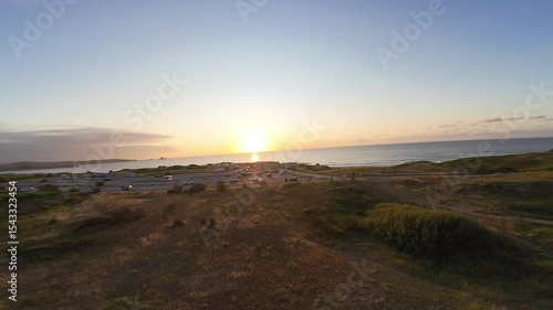 Nature, Coastal landscape, Ocean, Sea, Sand, Shore, Waves, Dunes, Cliff, Trees, Sunshine, Golden hour, Horizon, Tranquility, Scenic view, Wilderness, Seaside, Twilight, Breeze, Natural light, Outdoor 
