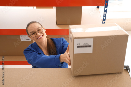 Smiling young woman in glas...