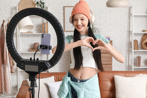 Teenage blogger in headphon...