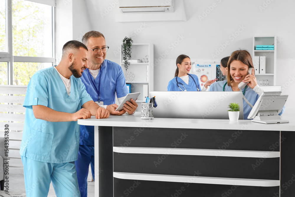 Fototapeta premium Group of medical interns working at reception in clinic