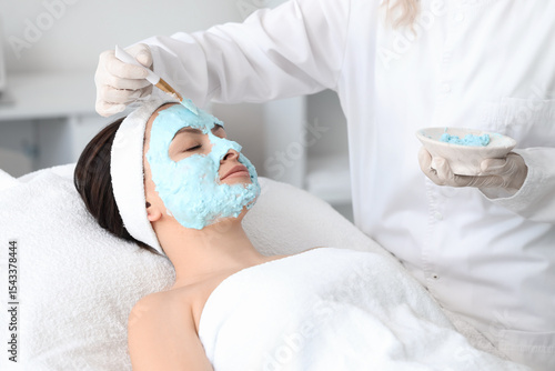 Female beautician applying ...