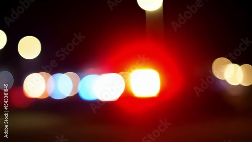 Out of focus flashing police lights on the car. Close-up. The lights of the patrol car are blurred. Glowing ambulance lights at night. Emergency assistance.