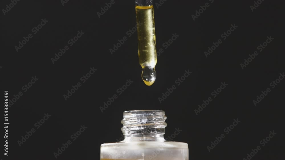 Mockup of glass bottle with dropper cap in female hands. Amber container with cosmetic product, serum on isolated background in sunlight. Beauty concept.