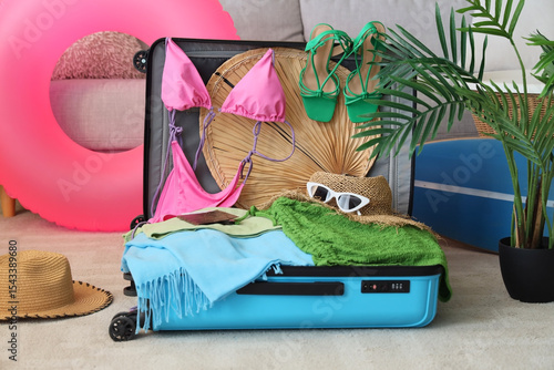 Open suitcase with beach ac...