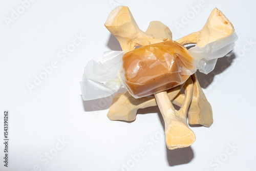 Canvas Print A caramel chew candy on a wooden tripod stand.