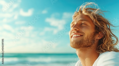 A young man with long hair smiles blissfully against a serene beach backdrop, capturing a moment of tranquility, joy, and the embrace of life's simple pleasures.